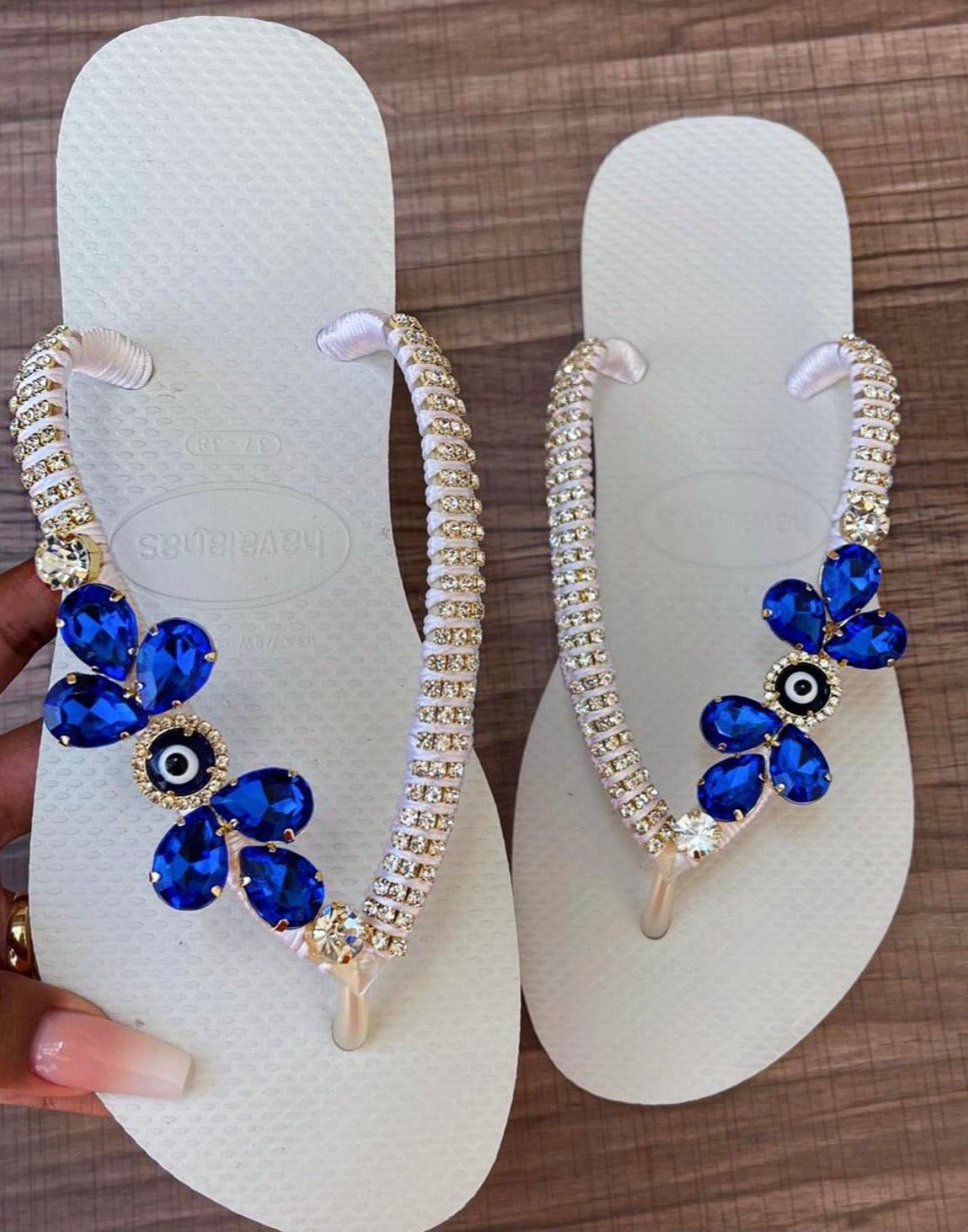 White flip flops with blue evil eye